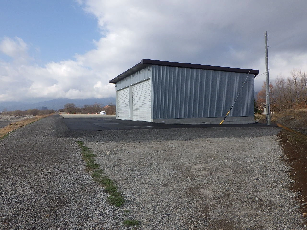 広い敷地に建つ格納庫を離れて見たところ