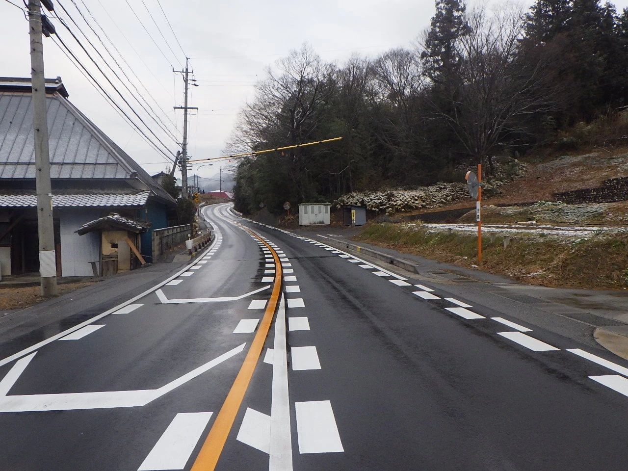 引き直した区画線が続く、民家の脇の道路