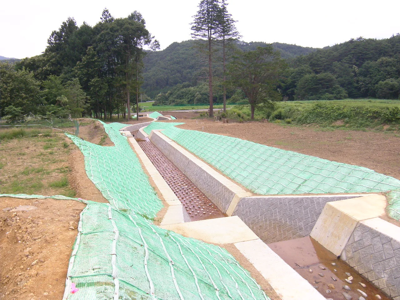 完成後の渓流。緑化マットを張った両岸と、石を敷いた水路・落差工